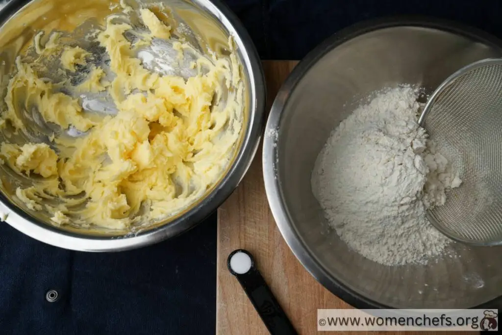 a bowl of creamed butter and a bowl of flour next to it