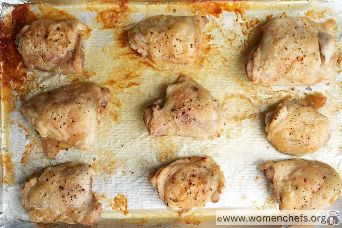 cooked chicken thighs on a baking tray
