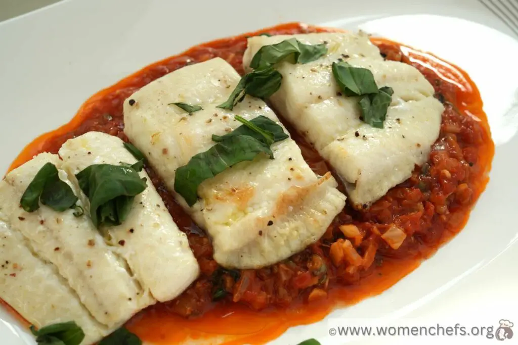 Baked halibut on a tomato and caper sauce