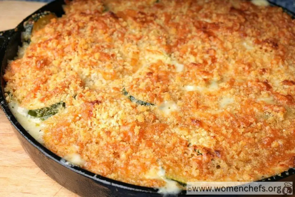 baked zucchini gratin with golden crust at the top on a large skillet pan