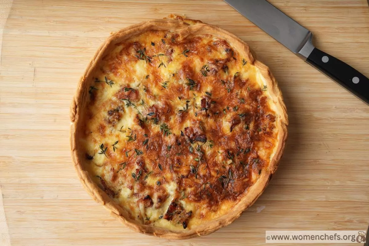 A whole Ina Garten quiche showing perfectly golden top and crust