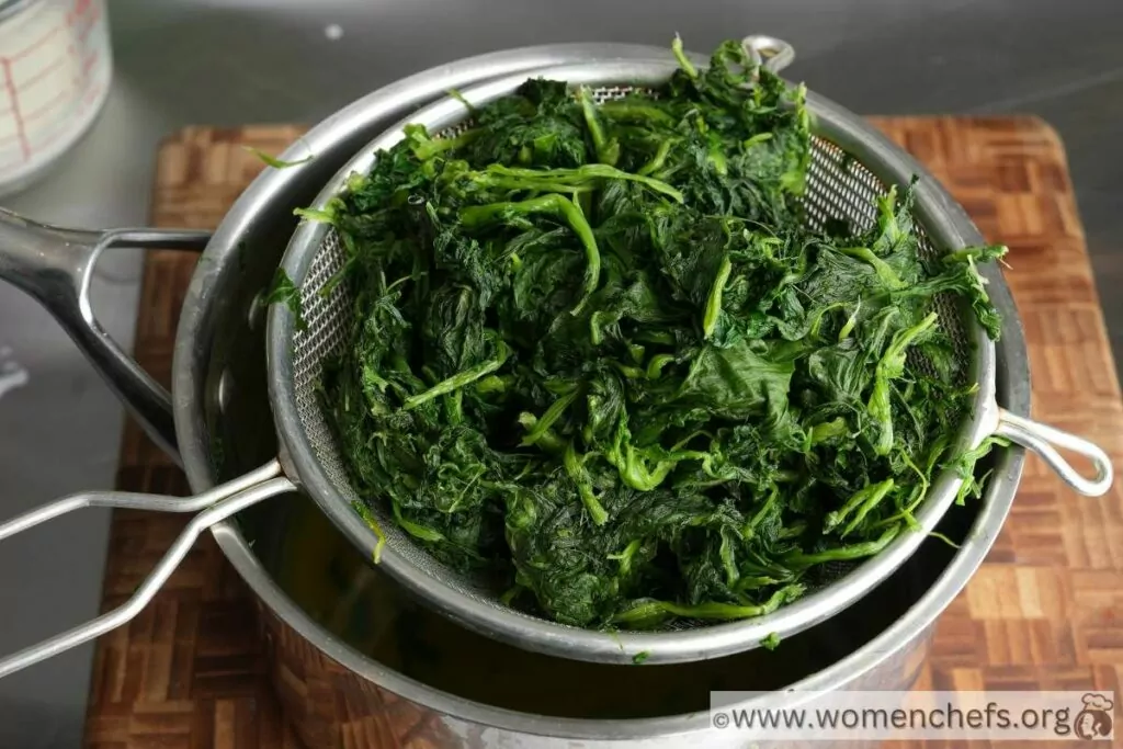 drained spinach over a sieve