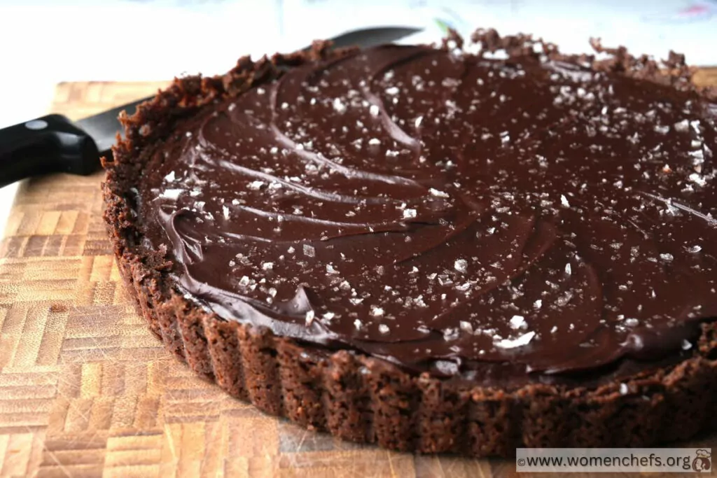 close up chocolate tart on a wooden board