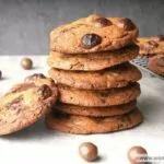 Ina Garten Chocolate Chip Cookies stacked up surrounded by Maltesers