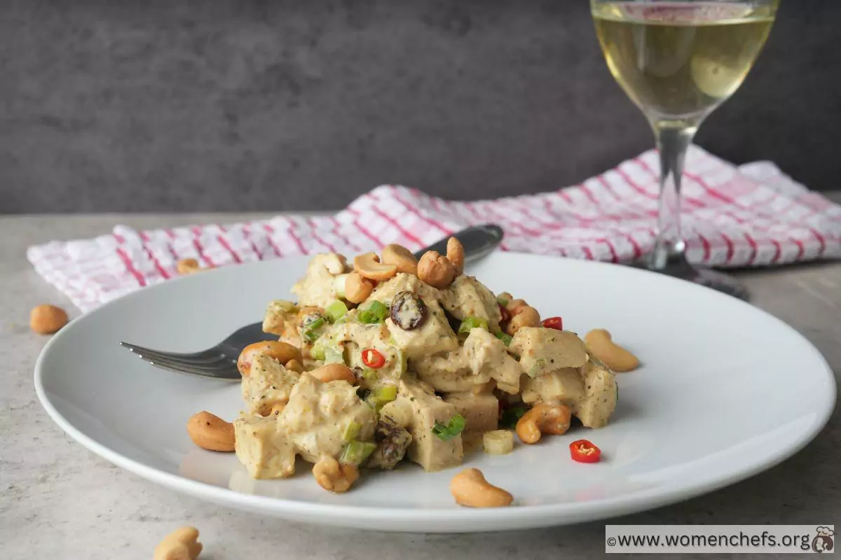 Ina Garten curry chicken salad on a plate with a wine